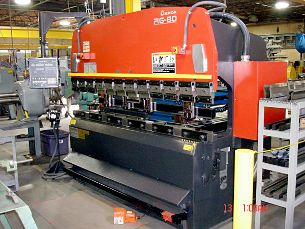 Amada RG-80 press brake machine used for precision metal bending in an industrial setting.