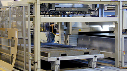 Automated metal handling and processing machine in a manufacturing facility.